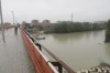 A woman walks by the Rhine River after heavy rainfall, in Bologna, Italy, Saturday, Oct. 19, 2024. (Michele Nucci/LaPresse via AP)
