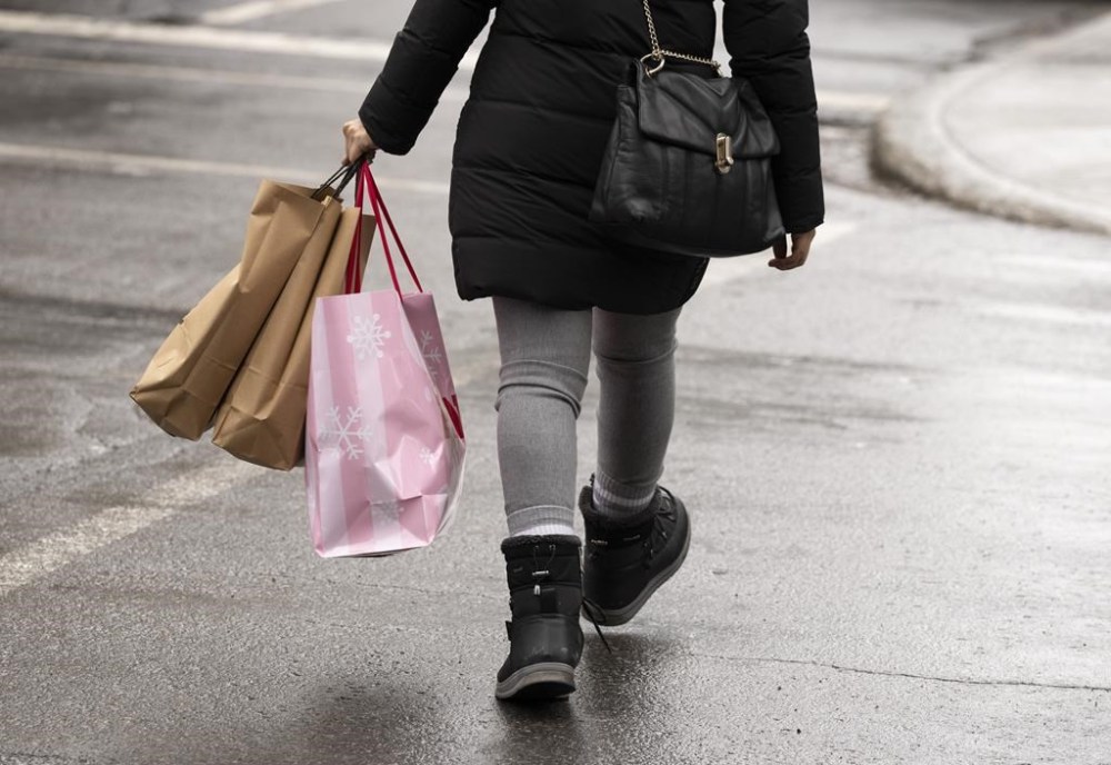 A shopper walks in downtown Montreal on December 19, 2023. THE CANADIAN PRESS/Christinne Muschi