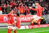 Mainz players celebrate after scoring their side's first goal of the game during the Bundesliga soccer match between FSV Mainz 05 and Borussia Mönchengladbach at the Mewa Arena in Mainz, Germany, Friday Sept. 25, 2024. (Torsten Silz/dpa via AP)