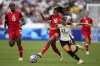 Canada's Ashley Lawrence fights for the ball with Germany's Klara Buehl during a women's quarterfinal soccer match between Canada and Germany at the 2024 Summer Olympics in Marseille, France, on August 3, 2024. THE CANADIAN PRESS/AP, Daniel Cole