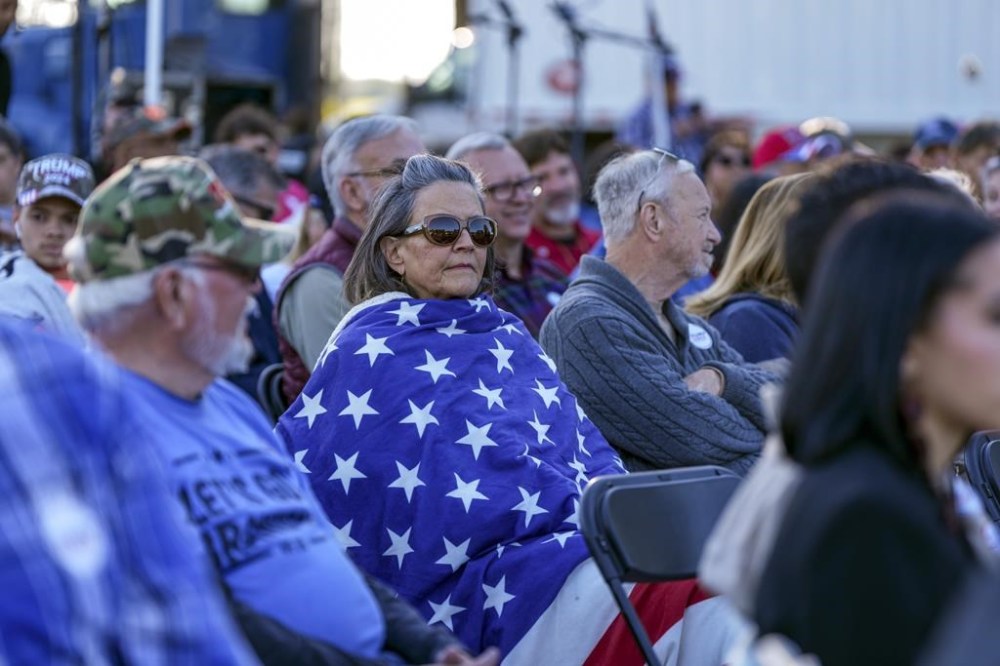 Supporter listen during a campaign event in support of Republican presidential candidate former President Donald Trump, Friday, Oct. 18, 2024, in Red Springs, N.C. (AP Photo/David Yeazell)