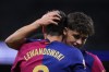 Barcelona's Robert Lewandowski, left, celebrates after scoring his side's opening goal during a Spanish La Liga soccer match between Real Madrid and Barcelona at the Santiago Bernabeu stadium in Madrid, Spain, Saturday, Oct. 26, 2024. (AP Photo/Manu Fernandez)