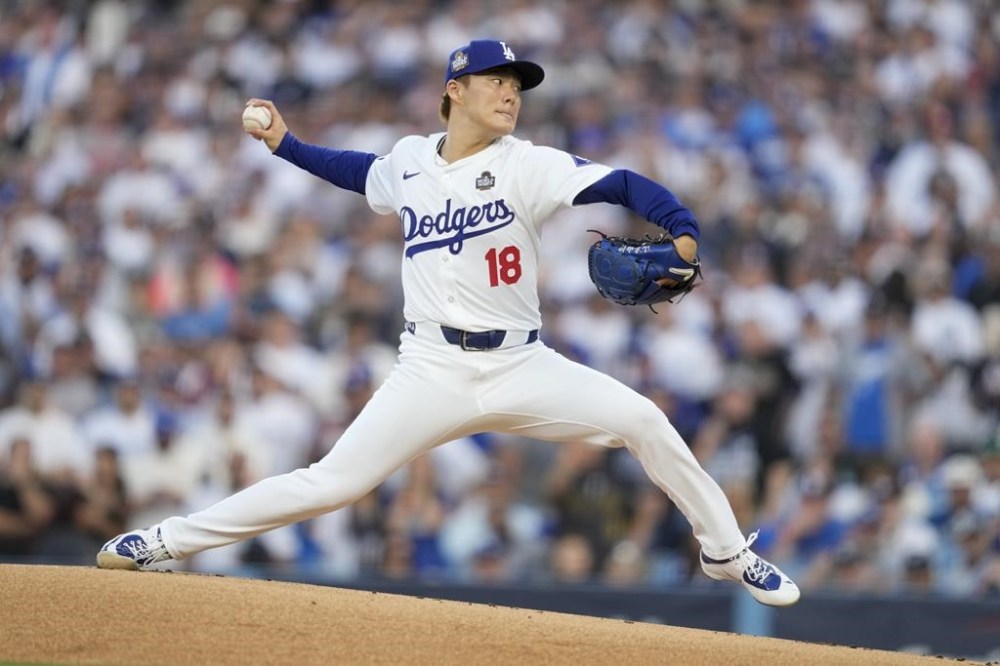 Los Angeles Dodgers pitcher Yoshinobu Yamamoto throws against the New York Yankees during the first inning in Game 2 of the baseball World Series, Saturday, Oct. 26, 2024, in Los Angeles. (AP Photo/Ashley Landis)