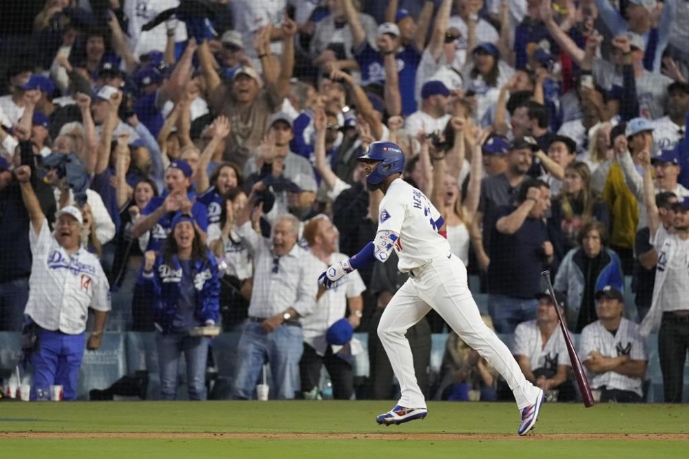 Los Angeles Dodgers' Teoscar Hernández watches his two-run home run during the third inning in Game 2 of the baseball World Series against the New York Yankees, Saturday, Oct. 26, 2024, in Los Angeles. (AP Photo/Mark J. Terrill)