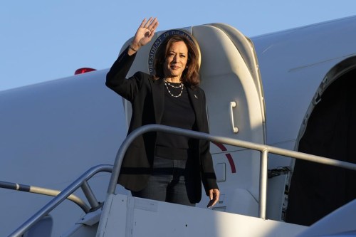 Democratic presidential nominee Vice President Kamala Harris waves as she boards Air Force Two at Philadelphia International Airport in Philadelphia, Sunday, Oct. 27, 2024, after spending the day campaigning in the city. (AP Photo/Susan Walsh)