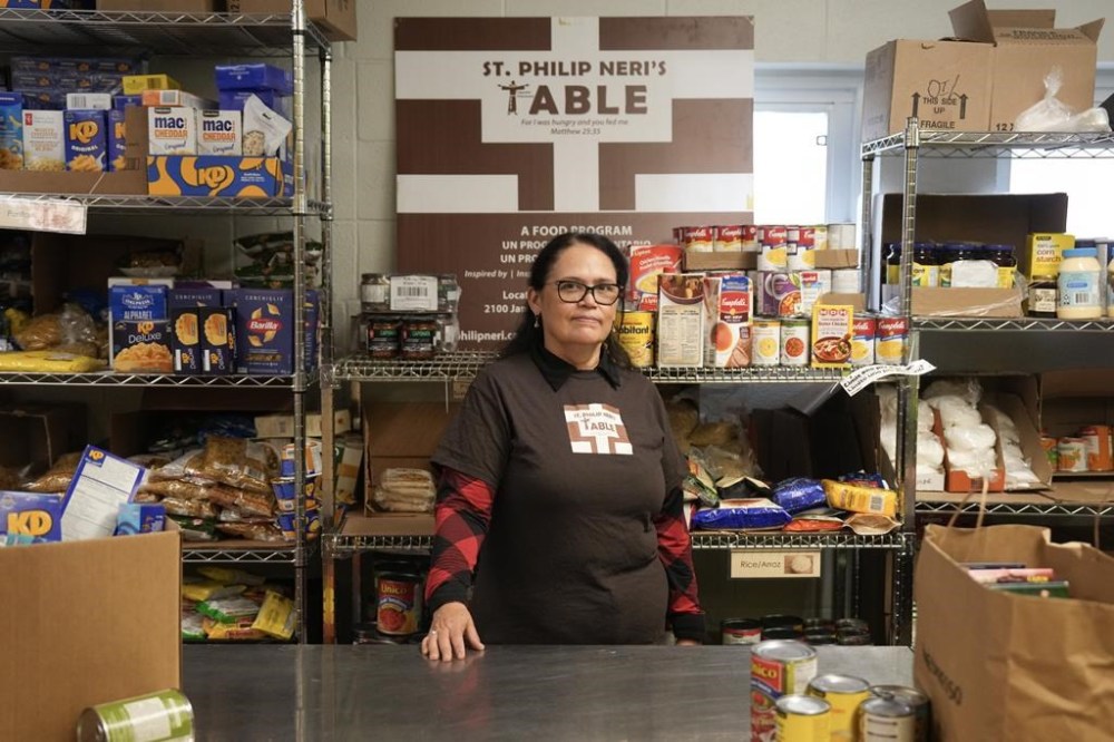Yesmil Pena, who works at St. Philip Neri’s Table Food Bank at St Philip Neri Church, is photographed in Toronto, Friday, Oct. 25, 2024. THE CANADIAN PRESS/Chris Young