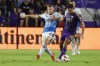 Charlotte FC midfielder Pep Biel (10) and Orlando City midfielder Martín Ojeda (11) fight for ball during the first half of a best-of-three first-round soccer match for the MLS Cup, Sunday, Oct. 27, 2024, in Orlando, Fla. (AP Photo/Kevin Kolczynski)