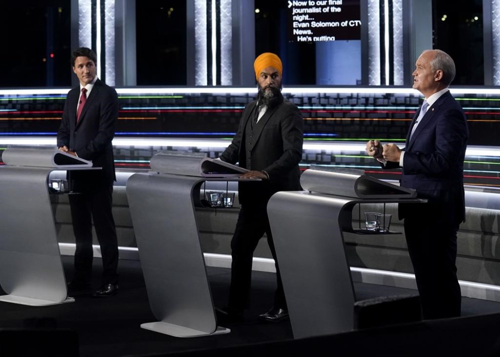 Liberal Leader Justin Trudeau, left to right, NDP Leader Jagmeet Singh and Conservative Leader Erin O'Toole take part in the federal election English-language leaders' debate in Gatineau, Que., on Thursday, Sept. 9, 2021. The Leaders' Debate Commission has selected two seasoned broadcast journalists to moderate the French and English leaders' debates in the next federal election. THE CANADIAN PRESS/Adrian Wyld