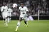 Real Madrid's Vinicius Junior runs with the ball during a Spanish La Liga soccer match between Real Madrid and Barcelona at the Santiago Bernabeu stadium in Madrid, Spain, Saturday, Oct. 26, 2024. (AP Photo/Bernat Armangue)