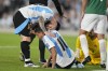 Argentina's Lionel Messi checks on teammate Nahuel Molina who sits on the pitch with an injury during a World Cup 2026 qualifying soccer match against Bolivia at Monumental stadium in Buenos Aires, Argentina, Tuesday, Oct. 15, 2024. (AP Photo/Natacha Pisarenko)