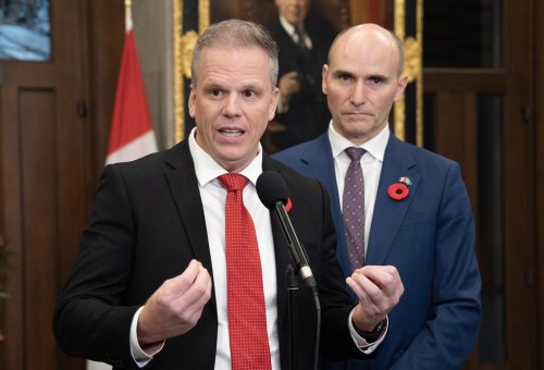 Public Services and Procurement Minister Jean-Yves Duclos looks on as Minister of Health Mark Holland speaks with reporters in the Foyer of the House of Commons, Monday, October 28, 2024 in Ottawa. THE CANADIAN PRESS/Adrian Wyld