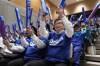 Oshu Mayor Jun Kuranari, center, and other people watch a live stream before the start of Game 3 of the baseball World Series between the Los Angeles Dodgers and the New York Yankees during a public viewing event in Oshu, northeastern Japan, the hometown of Shohei Ohtani of the Los Angeles Dodgers, Tuesday, Oct. 29, 2024. (AP Photo/Eugene Hoshiko)