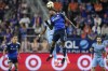 FC Cincinnati defender Alvas Powell (2) goes up for the ball in front of New York City FC midfielder Andrés Perea, center left, during the second half of a first-round soccer match of the MLS Cup playoffs, Monday, Oct. 28, 2024, in Cincinnati. (AP Photo/Carolyn Kaster)