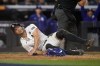 New York Yankees' Giancarlo Stanton lies on the ground after being tagged out while trying to score against the Los Angeles Dodgers during the fourth inning in Game 3 of the baseball World Series, Monday, Oct. 28, 2024, in New York. (AP Photo/Godofredo A. Vásquez)
