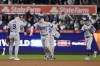 Los Angeles Dodgers' Gavin Lux (9), Kiké Hernández (8), Tommy Edman (25) and Mookie Betts (50) celebrate after Game 3 of the baseball World Series against the New York Yankees, Monday, Oct. 28, 2024, in New York. The Dodgers won 4-2. (AP Photo/Godofredo A. Vásquez)