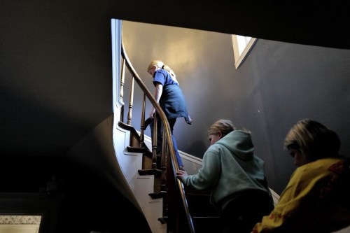 Visitors climb a spiral staircase, Wednesday, Oct. 16, 2024, while touring the Lizzie Borden House, site of an 1892 double axe murder, in Fall River, Mass. (AP Photo/Steven Senne)