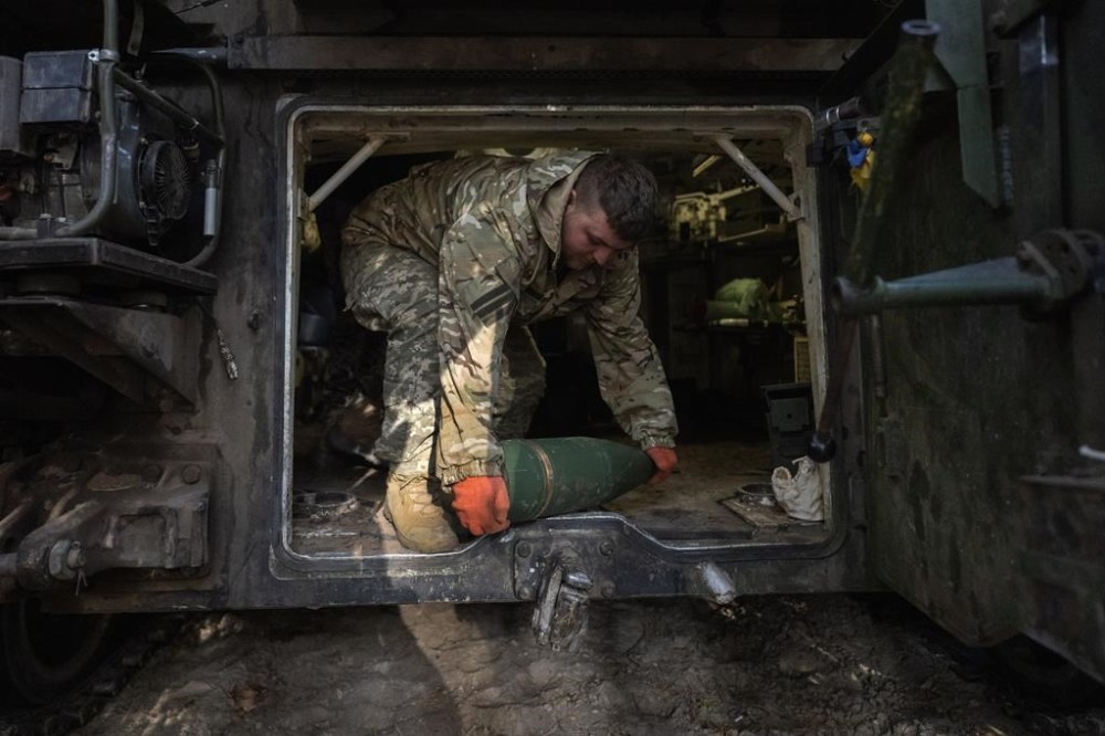 A Ukrainian soldier of the 92nd separate assault brigade prepares to fire a 155mm M-109