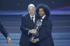 Qatar's Akram Afif, right, receives the player of the year award from FIFA President Gianni Infantino during the Asian Football Confederation or AFC Annual Award Seoul 2023, ceremony at the Grand Peace Palace in Seoul, South Korea, Tuesday, Oct. 29, 2024. (AP Photo/Lee Jin-man)