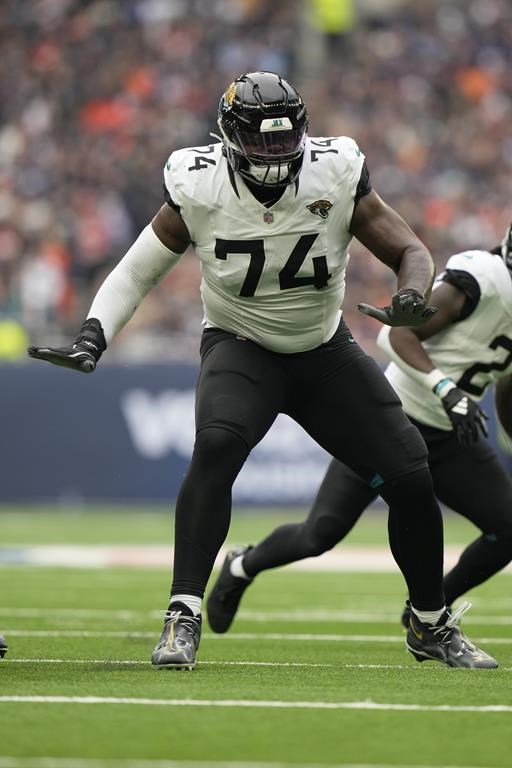 FILE - Jacksonville Jaguars offensive tackle Cam Robinson (74) in action against the Chicago Bears during an NFL football game at Tottenham Hotspur Stadium, Sunday, Oct. 13, 2024, in London. (AP Photo/Steve Luciano, File)