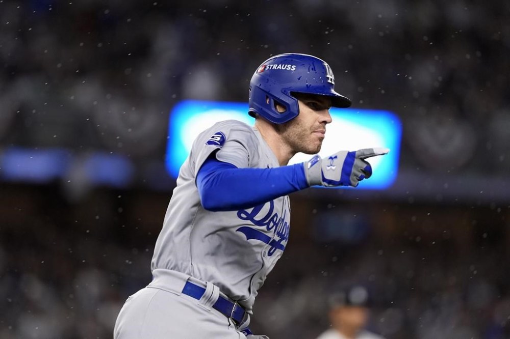 Los Angeles Dodgers' Freddie Freeman celebrates after hitting a two-run home run against the New York Yankees during the first inning in Game 4 of the baseball World Series, Tuesday, Oct. 29, 2024, in New York. (AP Photo/Godofredo A. Vásquez)