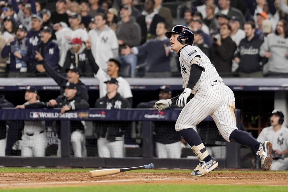 New York Yankees' Anthony Volpe celebrates his grand slam home run against the Los Angeles Dodgers during the third inning in Game 4 of the baseball World Series, Tuesday, Oct. 29, 2024, in New York. (AP Photo/Ashley Landis)