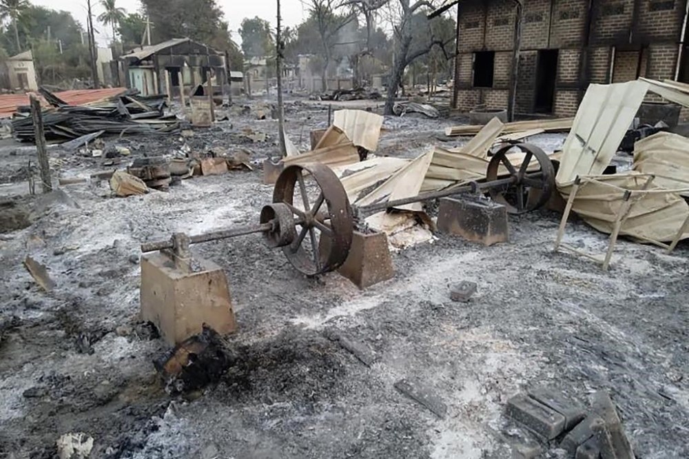 FILE - Charred homes sit in piles of ash in Mwe Tone village of Pale township in the Sagaing region, Myanmar, Feb. 1, 2022. (AP Photo, File)