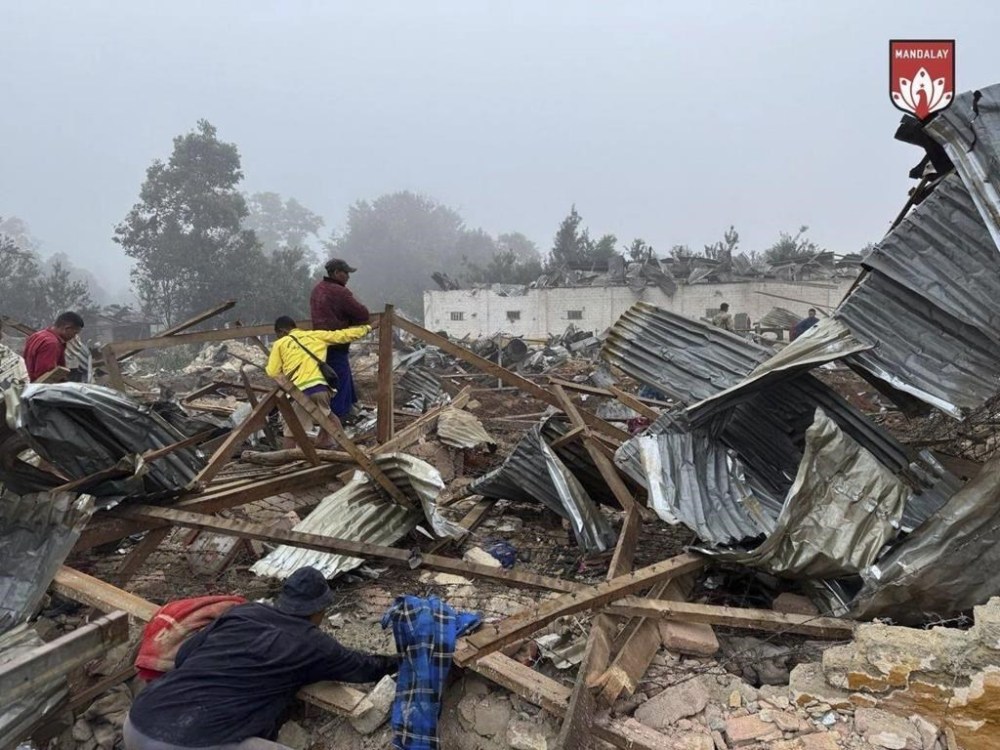 In this handout photo provided by Mandalay People's Defence Force, rescuers work in the debris of a jail building destroyed in an army airstrike in Nawnghkio township in Shan state, Myanmar, Tuesday, Oct. 29, 2024. (Mandalay People's Defence Force via AP)