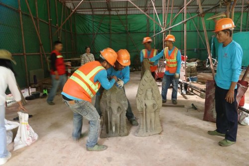 This handout photo provided by Apsaras National Authority shows centuries-old sandstone statues being arranged at Angkor Thom in Cambodia, Oct. 24, 2024. (Phouk Chea/Apsaras National Authority via AP)