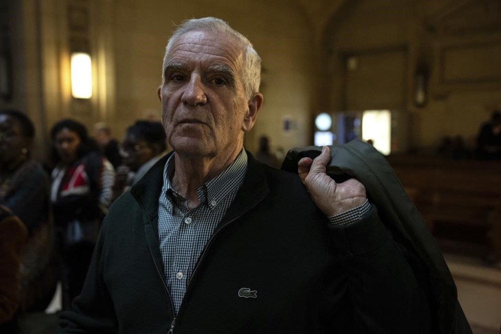 Alain Gauthier, founder of the Collective of Civil Parties for Rwanda, arrives at a Paris criminal court which is expected to render its verdict in the trial of Eugène Rwamucyo, a former doctor who is charged with genocide, complicity, crimes against humanity and conspiring to prepare those crimes for having allegedly played a role in the 1994 genocide of more than 800,000 minority Tutsis and moderate Hutus who tried to protect them, Wednesday, Oct. 30, 2024 in Paris. (AP Photo/Louise Delmotte)