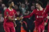 Liverpool's Cody Gakpo, left, celebrates with his teammate Curtis Jones after scoring the first goal during the English League Cup soccer match between Brighton and Liverpool at Falmer Stadium in Brighton, England, Wednesday, Oct. 30, 2024. (AP Photo/Dave Shopland)