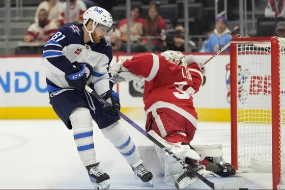 Winnipeg Jets left wing Kyle Connor (81) scores on Detroit Red Wings goaltender Alex Lyon (34) during the first period of an NHL hockey game, Wednesday in Detroit. (Carlos Osorio / The Associated Press)