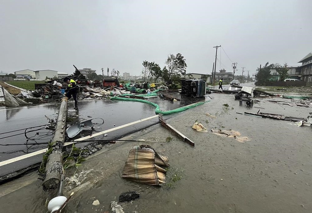In this photo released by Hualien County Fire Department, police check an area destroyed by the wind from Typhoon Kong-rey in Hualien County, eastern Taiwan, Thursday, Oct. 31, 2024. (Hualien County Fire Department via AP)