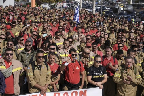 Hundreds of seasonal firefighters attend a protest outside Greece's Civil Protection Ministry to demand year-round contracts, in Athens, Thursday Oct. 31, 2024. (AP Photo/Thanassis Stavrakis)