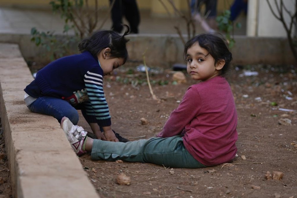 Displaced children, who fled Baalbek city and the nearby towns of Douris and Ain Bourday with their families amid the ongoing Hezbollah-Israel war, play inside a school being used as a shelter, in Deir Al-Ahmar, east Lebanon, Thursday, Oct. 31, 2024. (AP Photo/Hassan Ammar)
