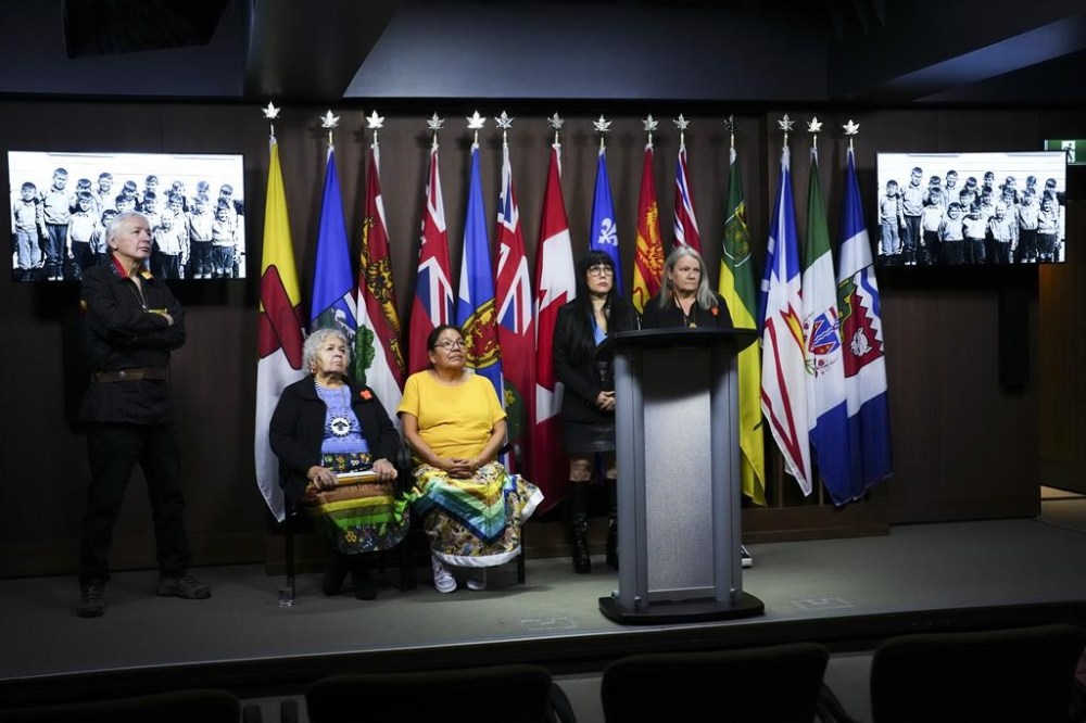NDP member of Parliament Leah Gazan, second from right, is joined by Special Interlocutor Kimberly Murray, right, and Indian Residential School survivors during a press conference on Parliament Hill in Ottawa on Thursday, Oct. 30, 2024. They are calling on the Government of Canada to recognize residential school denialism as inciting hate in the Criminal Code following the delivery of the final report of the Special Interlocutor for Missing Children and Unmarked Graves and Burial Sites Associated with Indian Residential Schools. THE CANADIAN PRESS/Sean Kilpatrick