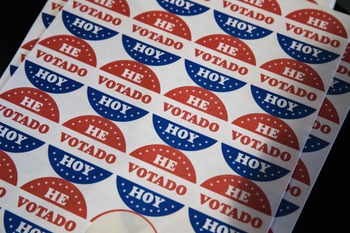 FILE - Spanish language voting stickers which read 