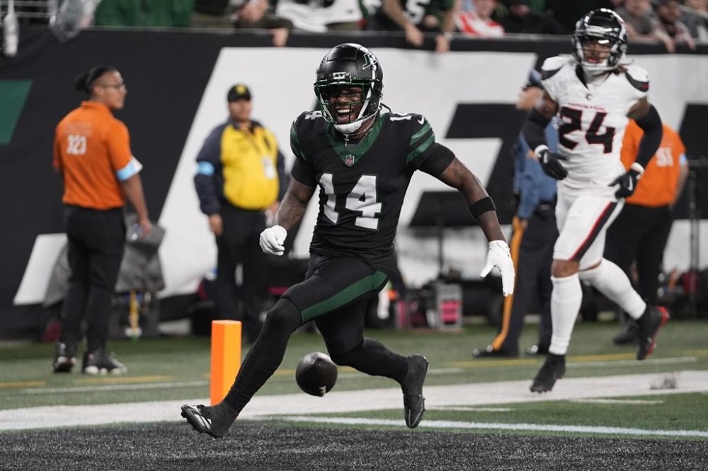New York Jets wide receiver Malachi Corley (14) drops the ball before scoring a touchdown during the first half an NFL football game against the Houston Texans, Thursday, Oct. 31, 2024, in East Rutherford, N.J. (AP Photo/Frank Franklin II)