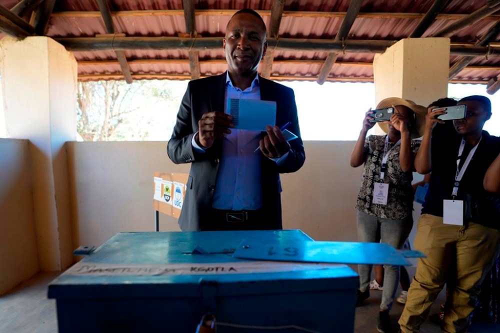 Umbrella for Democratic Change (UDC) presidential candidate Duma Boko holds his ballot paper before inserting it into the box during the elections in Gaborone, Botswana, Wednesday, Oct. 30, 2024. (AP Photo/Themba Hadebe)