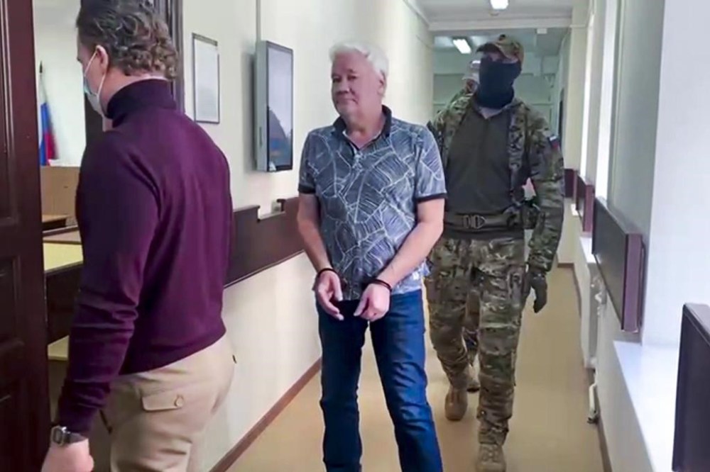 FILE - In this photo taken from video released by Lefortovo District Court, Robert Shonov, a Russian national who worked at the now-closed U.S. consulate in Vladivostok for more than 25 years, is escorted by officers to the court room at the Lefortovo District Court in Moscow, Russia, Thursday, May 18, 2023. (Lefortovo District Court via AP, File)
