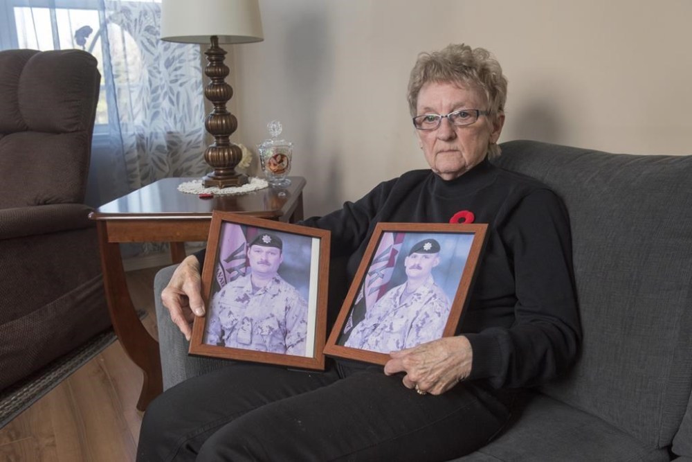 National Silver Cross Mother Maureen Anderson is shown with photos of her sons Sgt. Ron Anderson, left, and Sgt. Ryan Anderson, in her home in Oromocto, N.B., on Thursday, Oct. 31, 2024. THE CANADIAN PRESS/Stephen MacGillivray