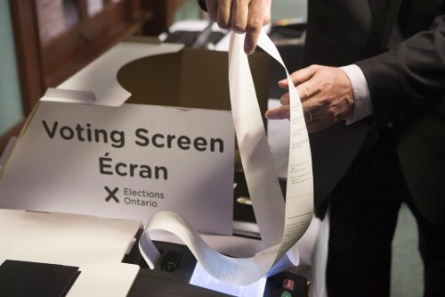 Ontario's Chief Electoral Officer Greg Essensa demonstrates an electronic voting machine during a media availability in Toronto on Wednesday, May 9 , 2018. The rise of artificial intelligence and its ability to rapidly spread misinformation and disinformation during election campaigns should be addressed by increasing transparency around political ads and allowing for the removal of misleading content about the electoral process, Essensa recommends.THE CANADIAN PRESS/Chris Young