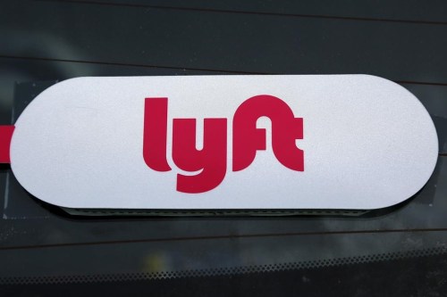 FILE - A Lyft logo is seen on a Lyft driver's car in Pittsburgh, Jan. 31, 2018. (AP Photo/Gene J. Puskar, File)