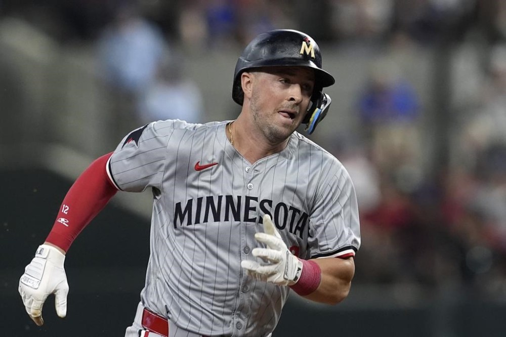 FILE - Minnesota Twins' Kyle Farmer sprints to third during a baseball game against the Texas Rangers, Thursday, Aug. 15, 2024, in Arlington, Texas. (AP Photo/Tony Gutierrez, File)