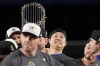Los Angeles Dodgers' Shohei Ohtani celebrates with the trophy after their win against the New York Yankees in Game 5 to win the baseball World Series, Thursday, Oct. 31, 2024, in New York. (AP Photo/Ashley Landis)