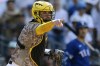 FILE - San Diego Padres catcher Gary Sanchez points towards first base in the ninth inning of a baseball game against the Texas Rangers Sunday, July 30, 2023, in San Diego. (AP Photo/Derrick Tuskan, File)