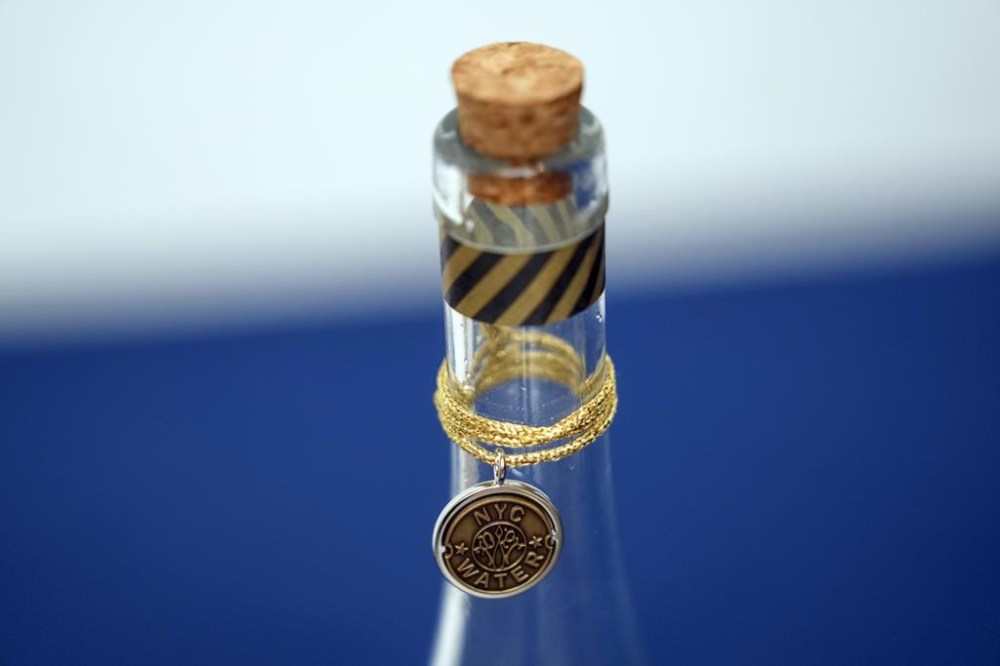 FILE - A bottle containing NYC tap water is displayed at a news conference about repairs occurring to the water supply infrastructure in New York, Sept. 30, 2024. (AP Photo/Seth Wenig, File)