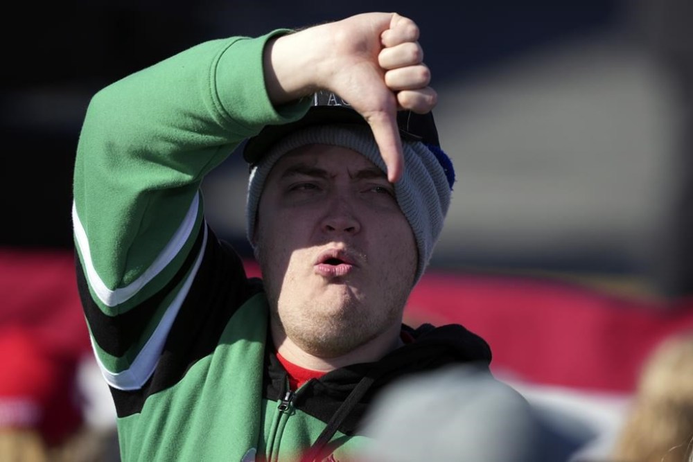 A supporter of Republican presidential nominee former President Donald Trump gestures to the media at a campaign rally in Lititz, Pa., Sunday, Nov. 3, 2024. (AP Photo/Matt Rourke)