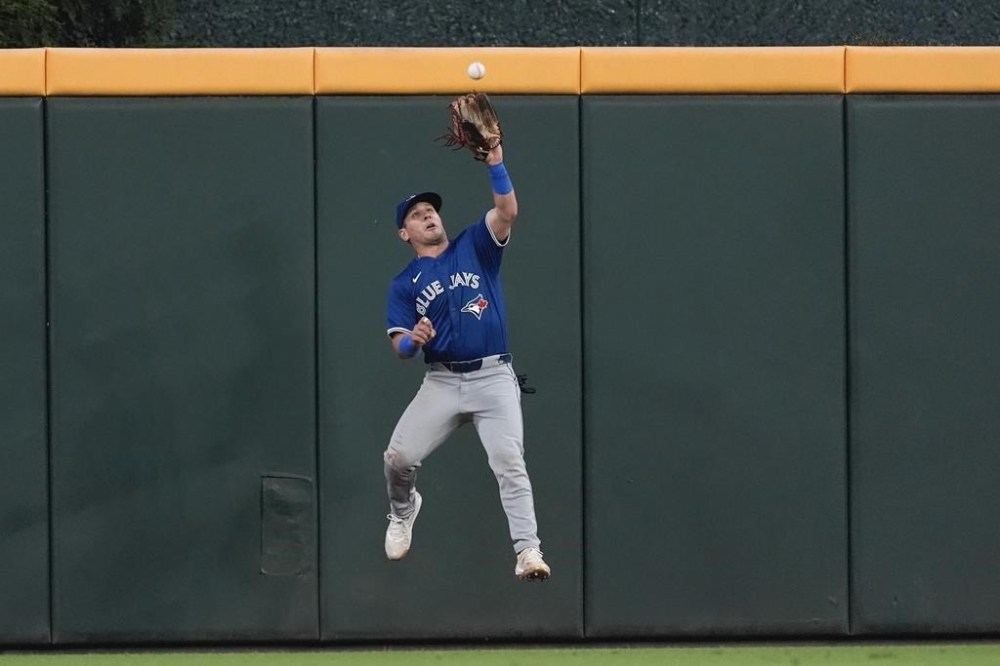 Toronto Blue Jays center fielder Daulton Varsho catches a fly ball off the bat of Atlanta Braves' Michael Harris II in the fourth inning of a baseball game Friday, Sept. 6, 2024, in Atlanta. (AP Photo/John Bazemore)