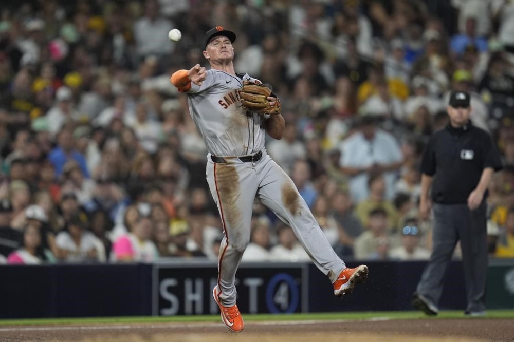 FILE - San Francisco Giants third baseman Matt Chapman throws to first for the out on San Diego Padres' Xander Bogaerts during the sixth inning of a baseball game, Sept. 6, 2024, in San Diego. (AP Photo/Gregory Bull, File)