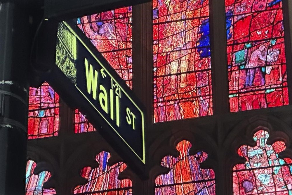 FILE - A sign marking Wall Street is shown near Trinity Church in New York's Financial District on Oct. 30, 2024. (AP Photo/Peter Morgan, File)